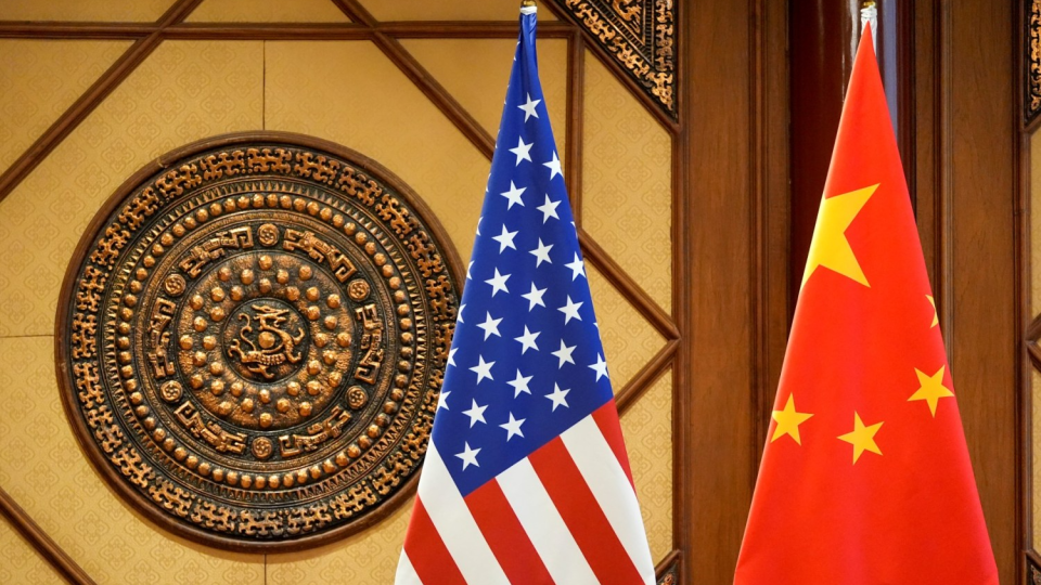 Flags of the U.S. and China sit in a room where U.S. Secretary of State Antony Blinken meets with Chinas Minister of Public Security Wang Xiaohong